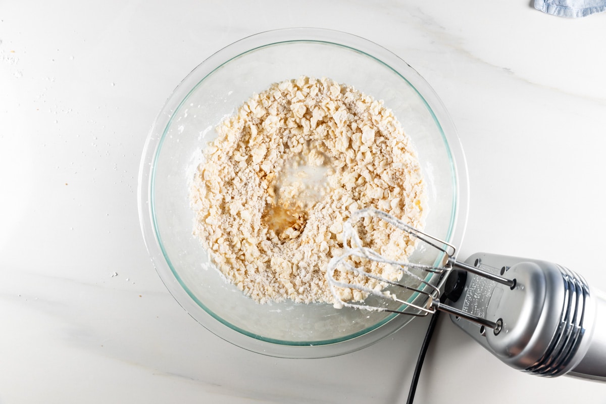 process shot of pumpkin cinnamon rolls being made.