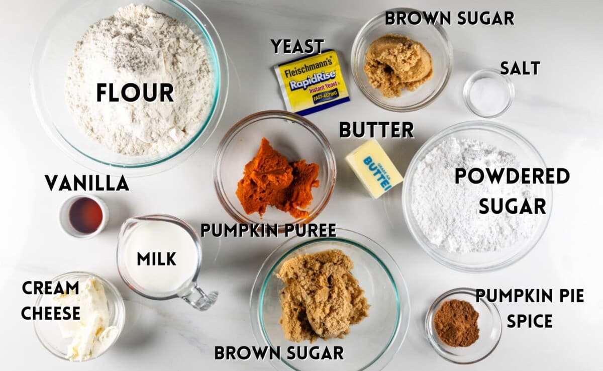 ingredients in pumpkin cinnamon rolls laid out on a white counter.