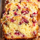 sliced cranberry bread on a cutting board.