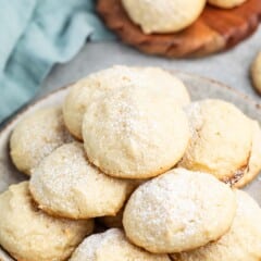 stacked cookies with powdered sugar sprinkled over top.