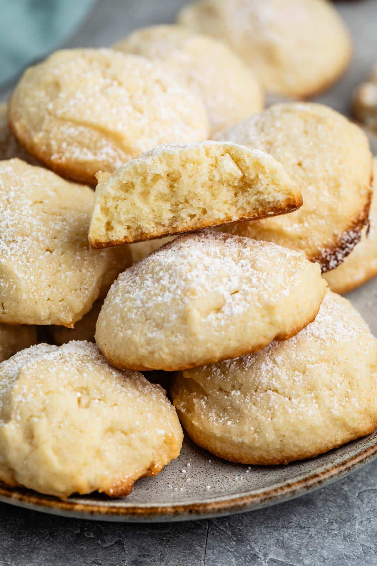 stacked cookies with powdered sugar sprinkled over top.