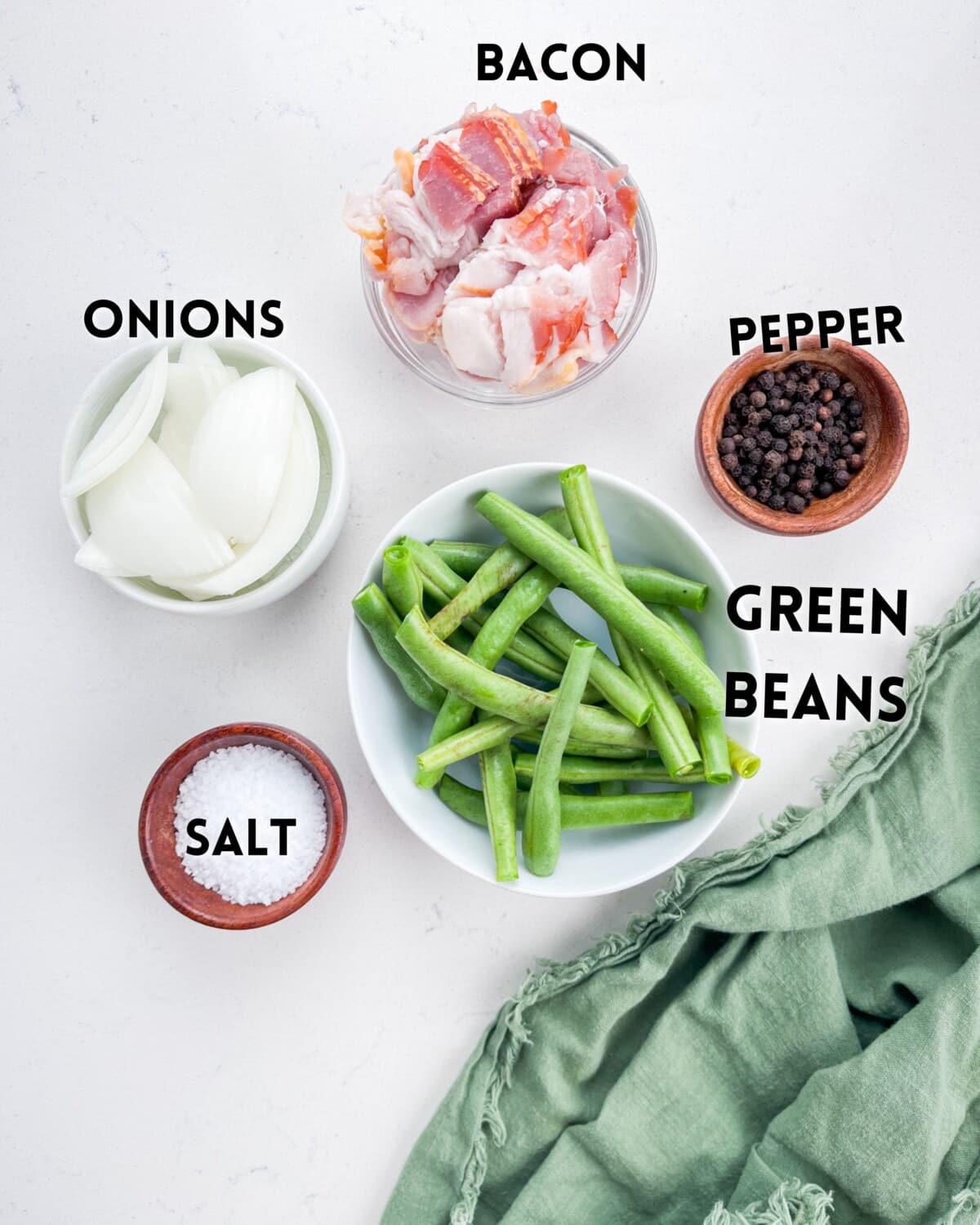 ingredients in green beans laid out on a white counter.