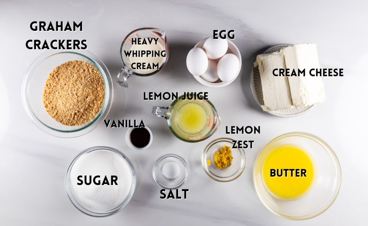 ingredients in lemon cheesecake laid out on a white counter.