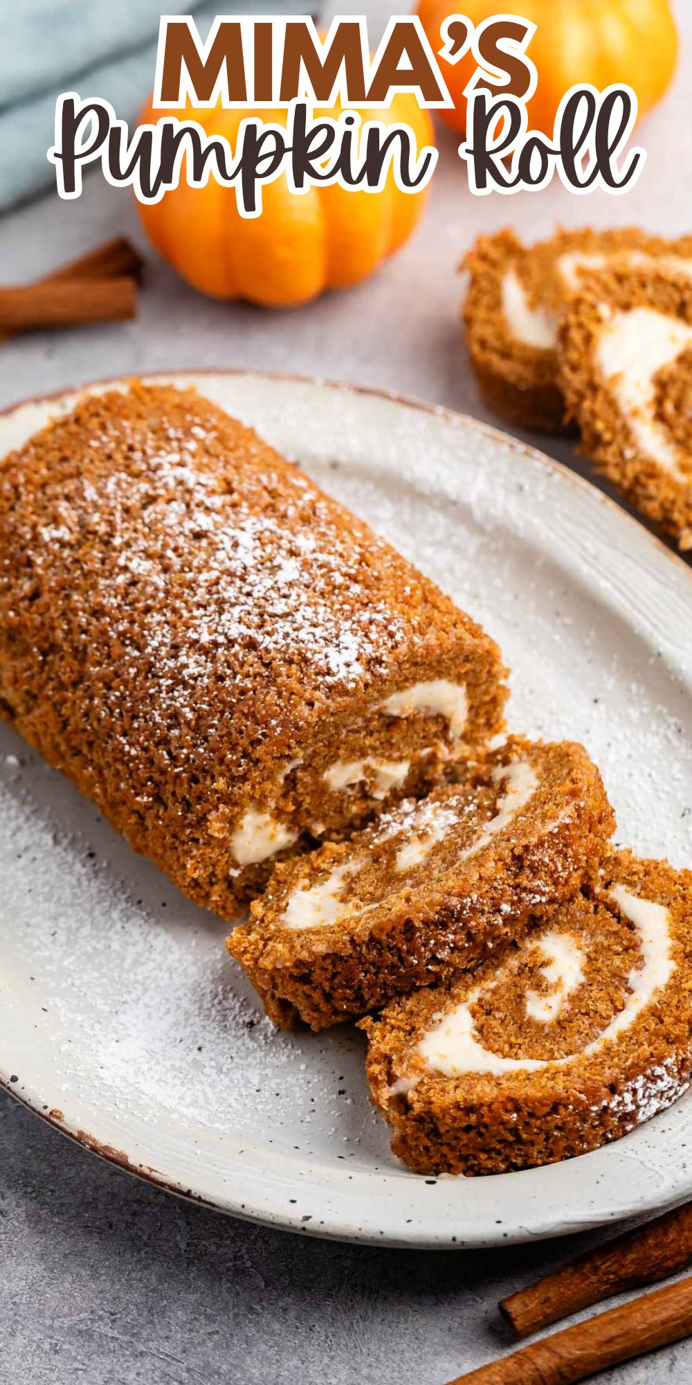 sliced pumpkin cake roll with a white buttercream in the center with words on the image.