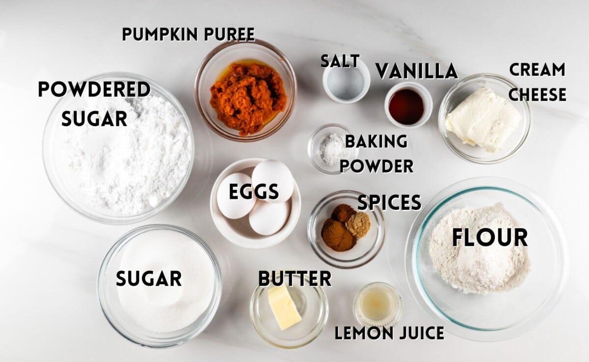 ingredients in pumpkin roll laid out on a white marble counter.