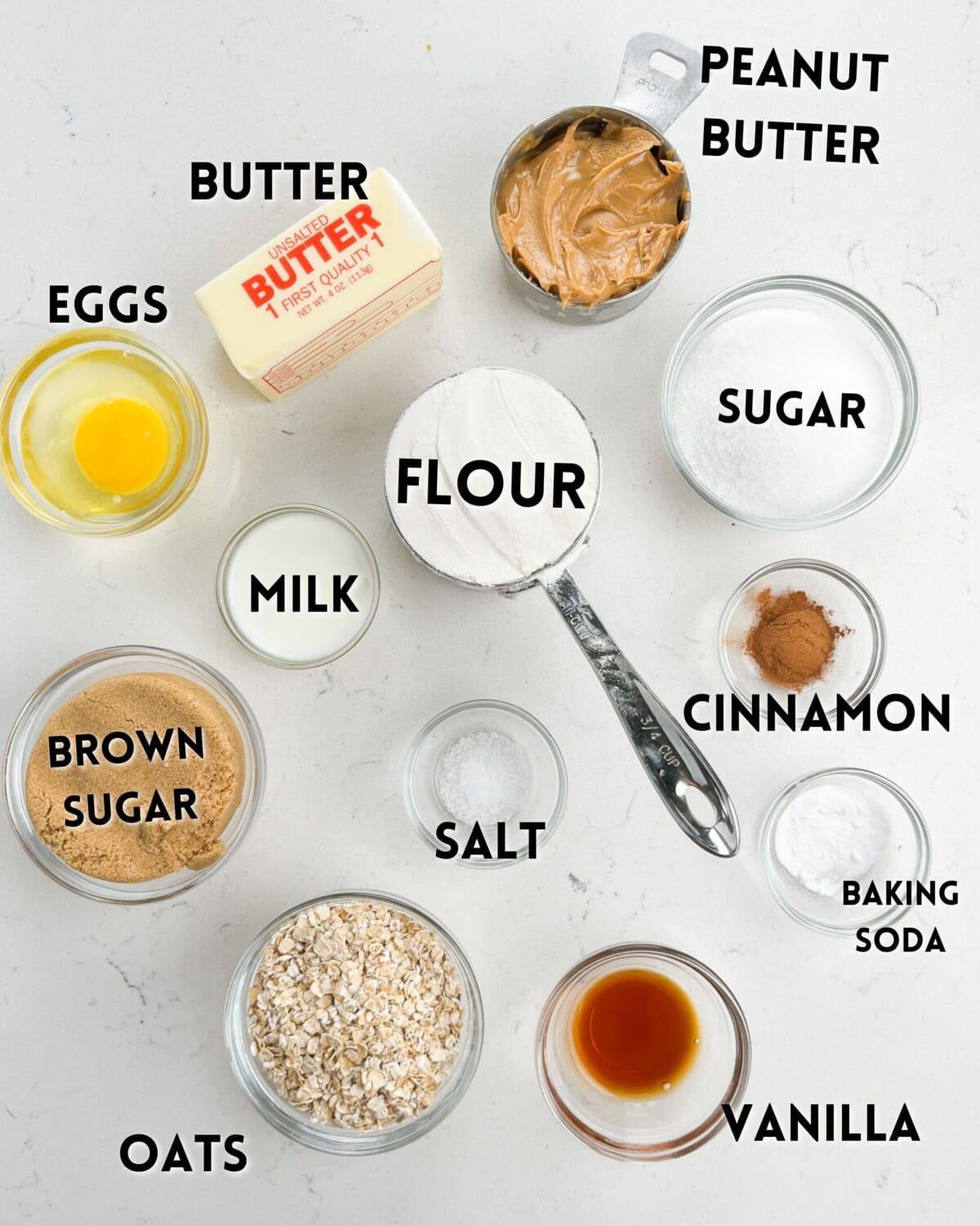 ingredients in peanut butter oatmeal cookies laid out on a white counter.