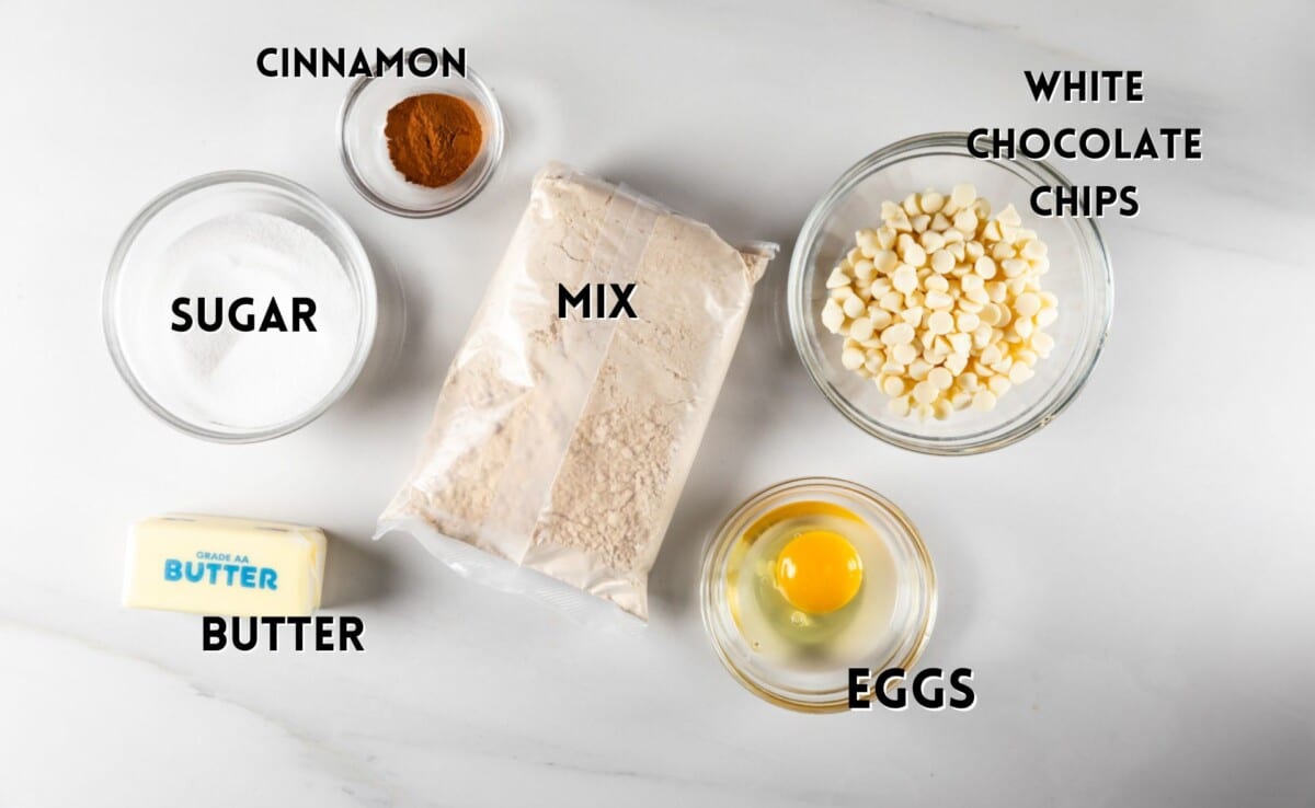 ingredients in pumpkin bread cookies laid out on a white counter.