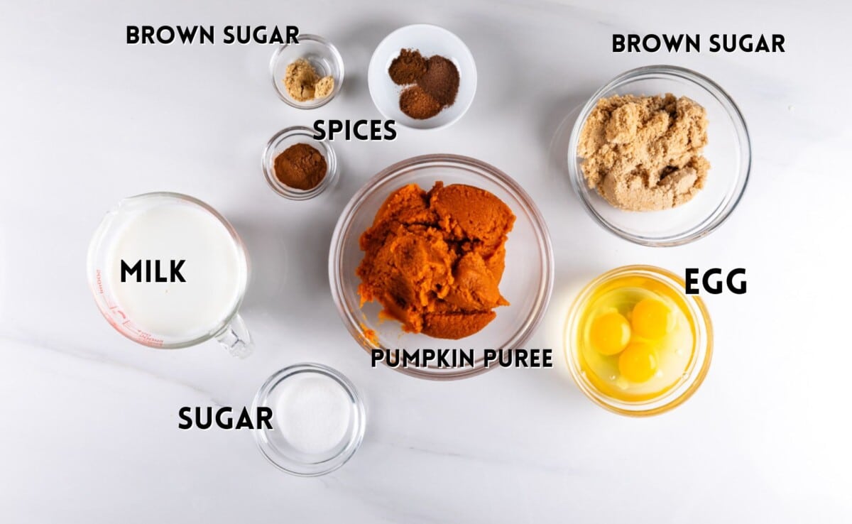 ingredients in pumpkin pie laid out on a white counter.