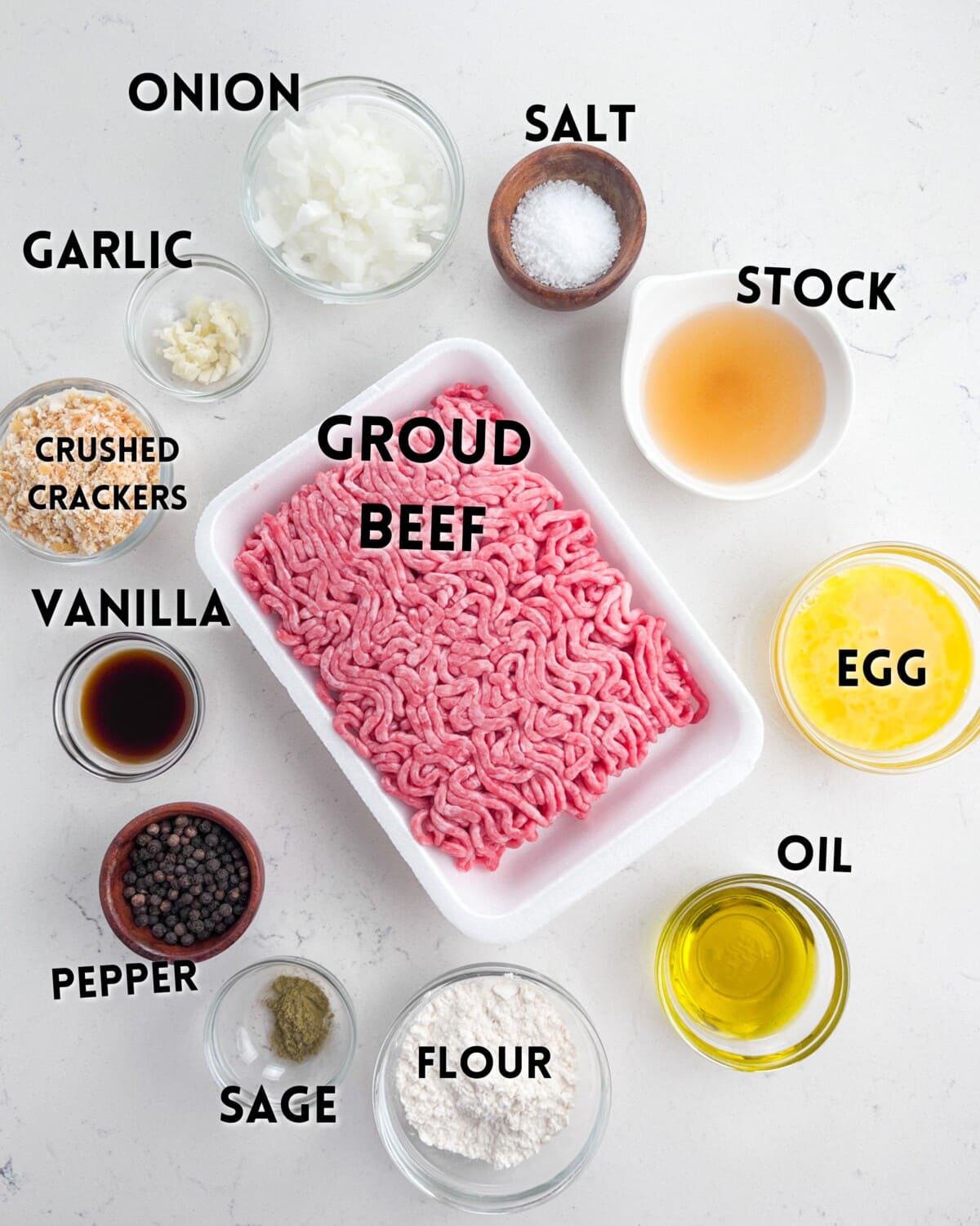 ingredients in salisbury steak laid out on a white counter.