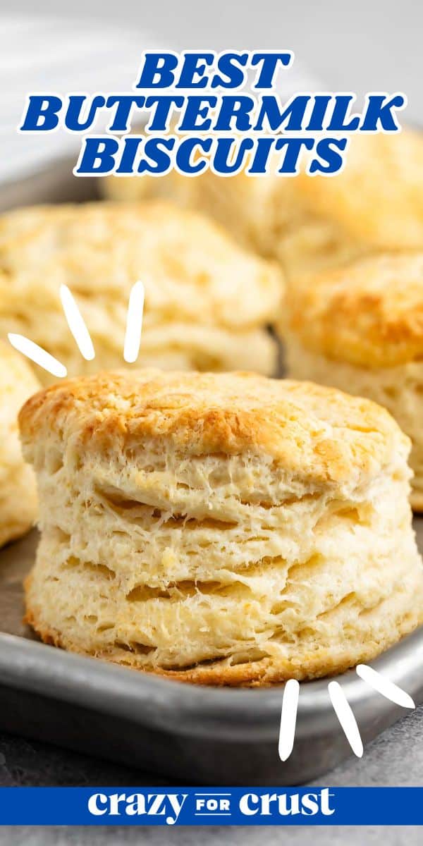 Close-up image of a freshly baked, flaky buttermilk biscuit on a tray, with emphasis lines highlighting its texture. The text at the top reads Best Buttermilk Biscuits and at the bottom crazy for crust.