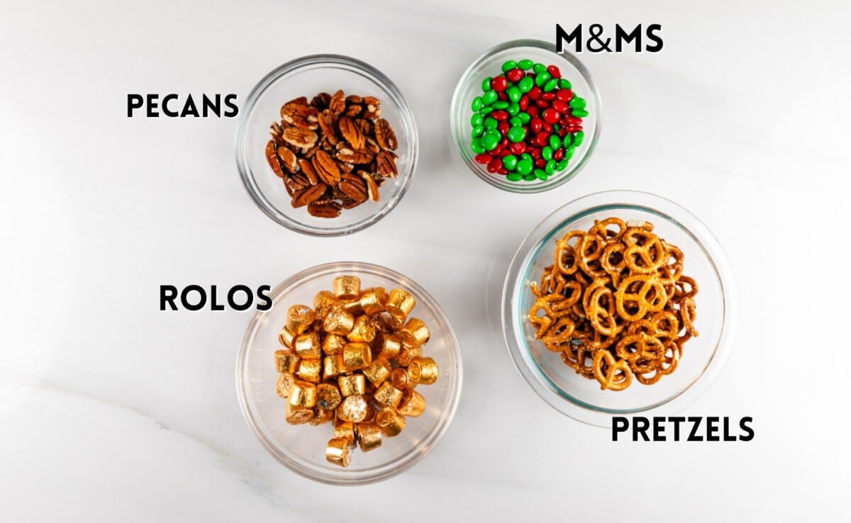 Four glass bowls containing different snacks are labeled: pecans, red and green M&Ms, Rolos, and pretzels.