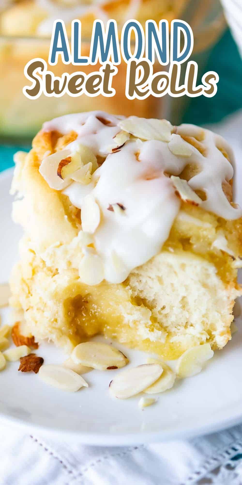 A close-up of a sweet roll topped with creamy icing and sliced almonds on a white plate. The background includes the text Almond Sweet Rolls in playful font.