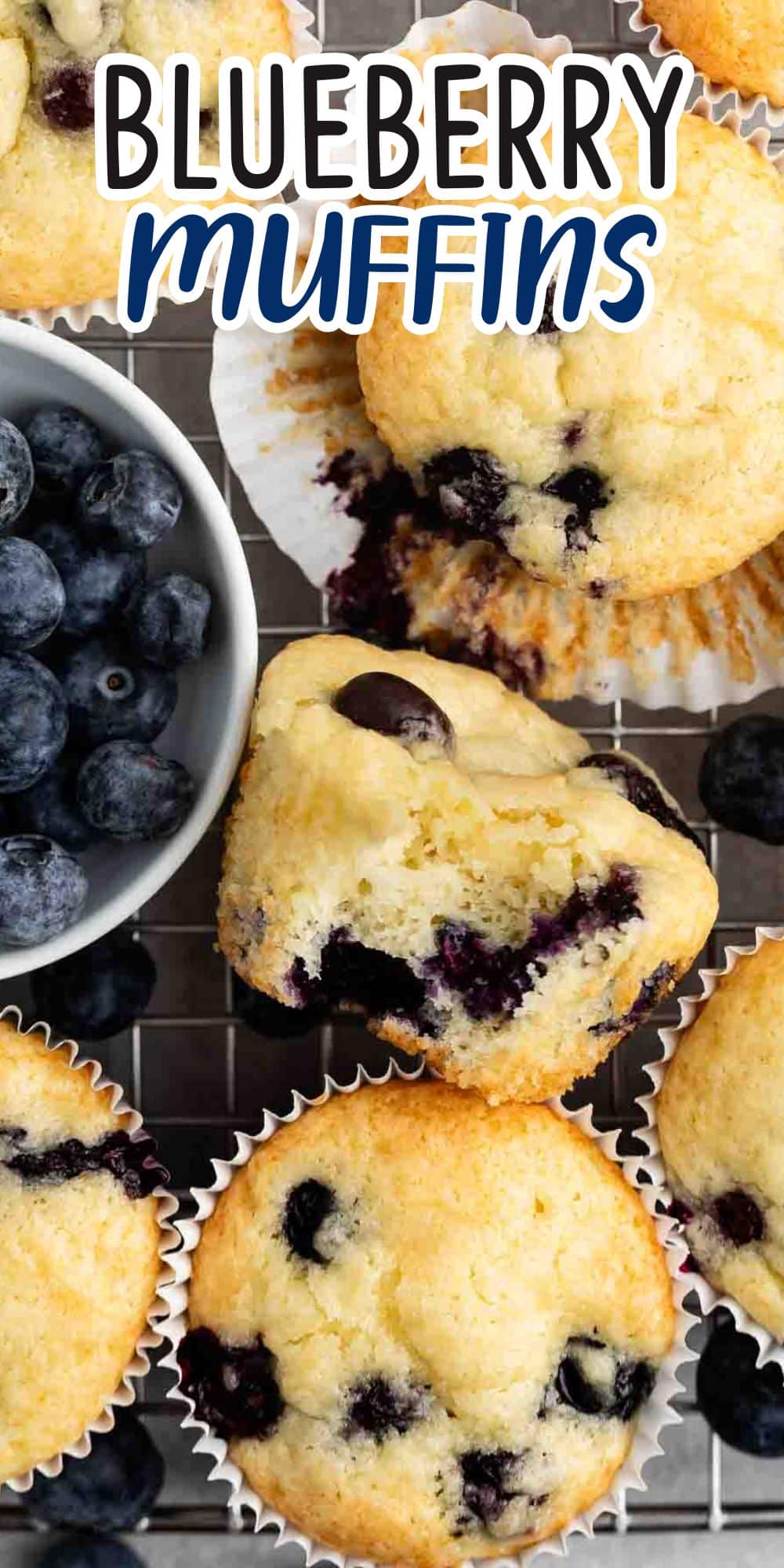 A close-up of freshly baked blueberry muffins on a cooling rack, with one muffin partially eaten. To the side, theres a small bowl filled with fresh blueberries. The text Blueberry Muffins appears at the top in stylized lettering.