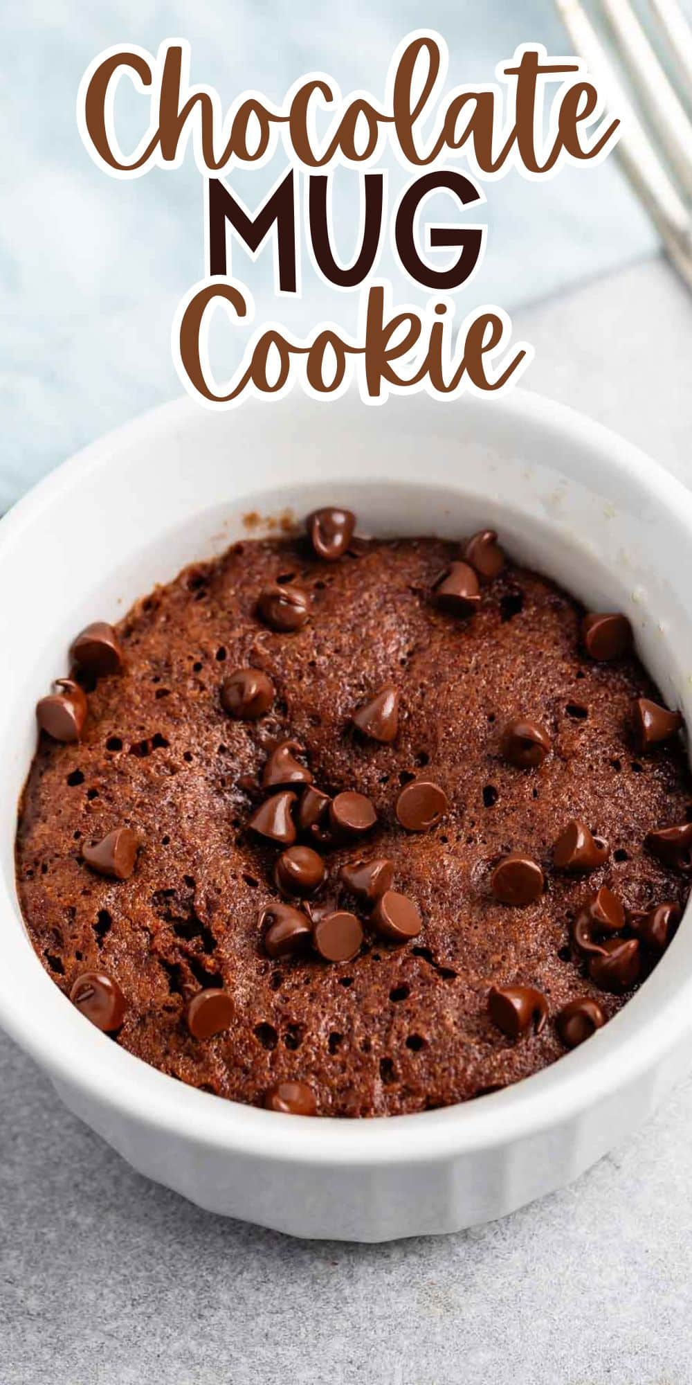 A chocolate mug cookie with chocolate chips is served in a white bowl. The text above reads Chocolate Mug Cookie.