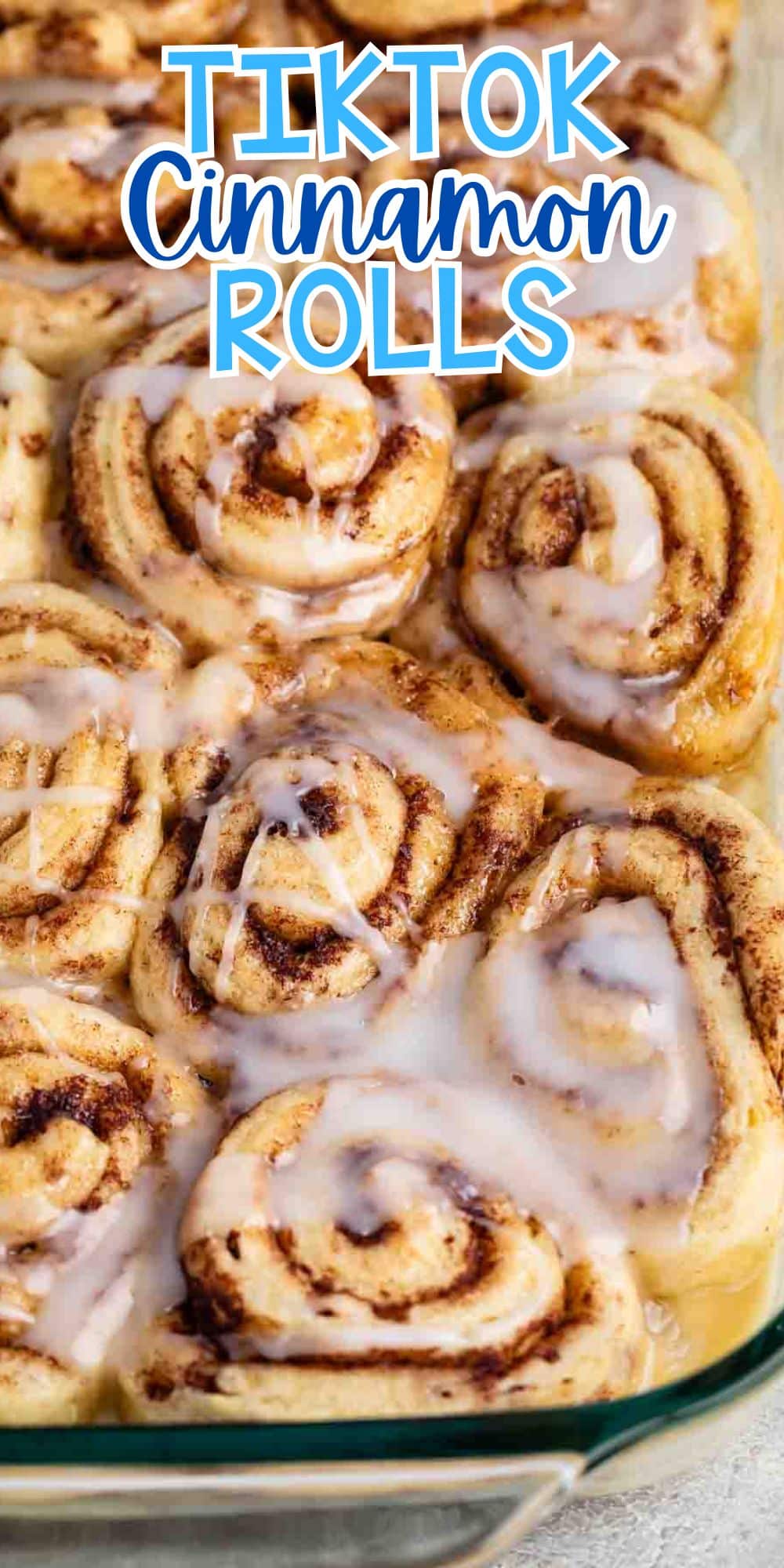 A close-up of freshly baked cinnamon rolls with icing drizzled on top, placed in a glass baking dish. Text at the top reads TIKTOK Cinnamon Rolls in bold letters.